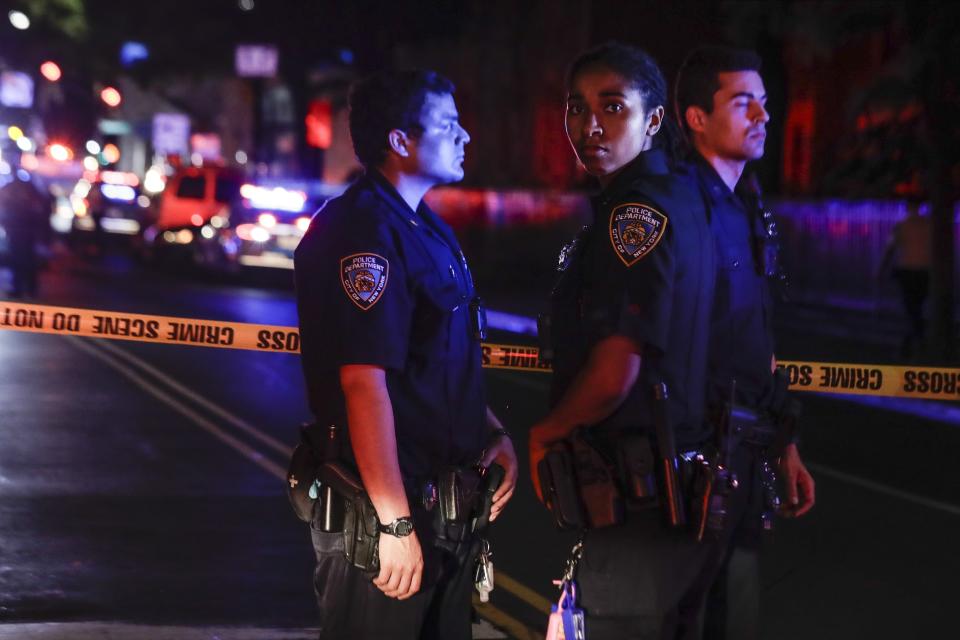 New York City police stand on a street early Thursday, June 4, 2020, in the Brooklyn borough of New York, after a police officer was shot. The police department says an officer has been shot in Brooklyn. The shooting happened late Wednesday, nearly four hours after an 8 p.m. curfew went into effect intended to quell unrest over the death of George Floyd in Minnesota. Details on the shooting, including the officer's condition, weren’t immediately available. (AP Photo/Frank Franklin II)