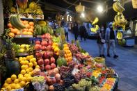 FILE PHOTO: People wearing protective face masks walk at a local market in Istanbul