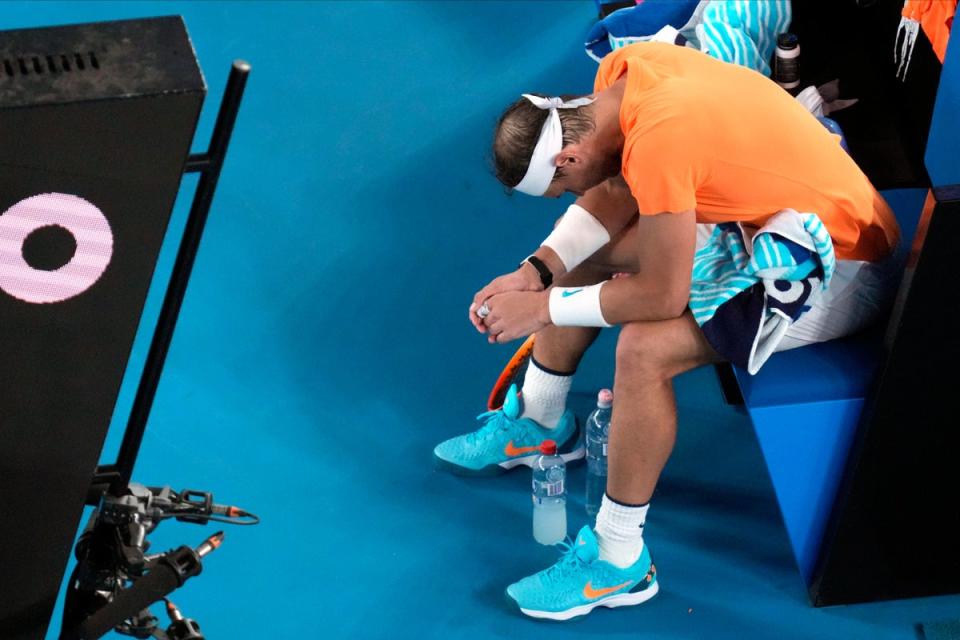Rafael Nadal hangs his head after suffering an apparent hip injury (AP)