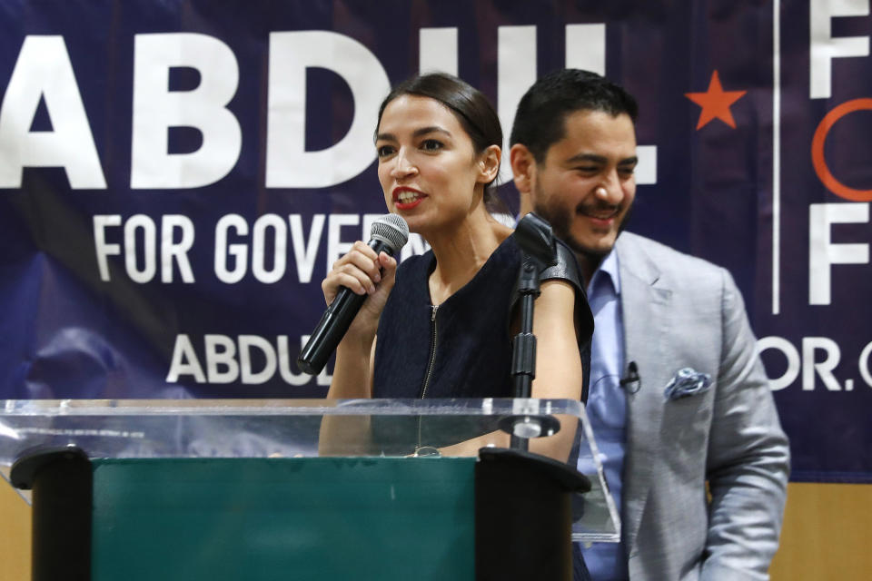 FILE - In this Saturday, July 28, 2018, file photo, Alexandria Ocasio-Cortez, a Democratic congressional candidate from New York, speaks during a campaign stop for Michigan for Democratic gubernatorial candidate Abdul El-Sayed, right, in Detroit. Ocasio-Cortez is trying to leverage the 17,000 votes that gave her a primary win in New York into a national movement. (AP Photo/Paul Sancya, File)