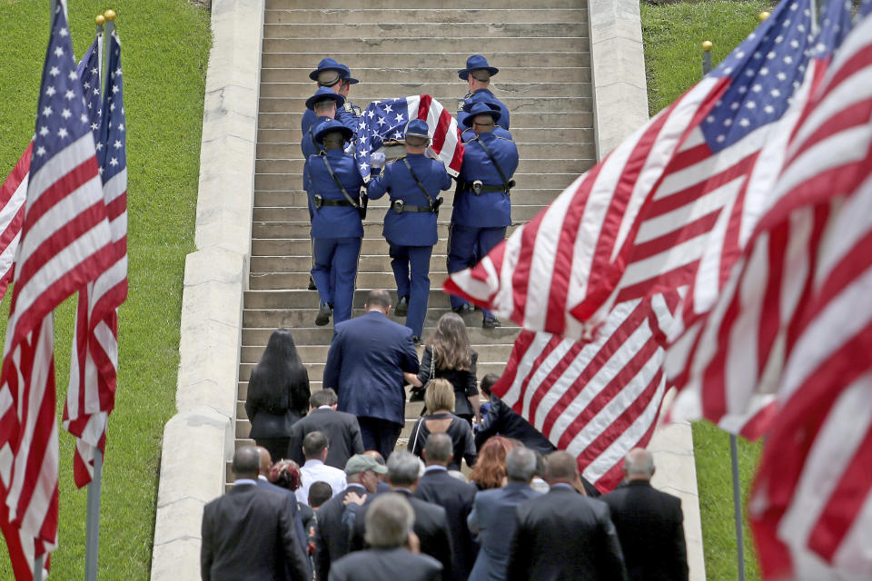 The flag-draped casket of former Louisiana Governor Edwin Edwards is carried up the steps of the Old State Capitol building following a processional through the streets of Baton Rouge, La., Sunday, July 18, 2021. The processional featuring a law enforcement motorcade as well as the Southern University Marching Band and ended at the Old State Capital building where a private funeral service was held. The colorful and controversial four-term governor died of a respiratory illness on Monday, July 12th at the age of 93. (AP Photo/Michael DeMocker)