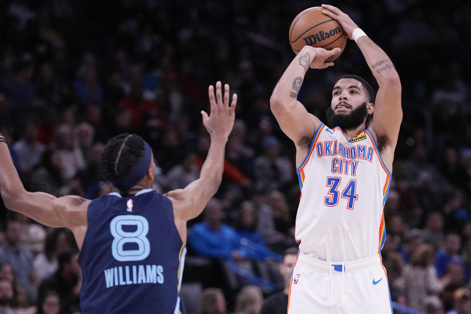 Oklahoma City Thunder forward Kenrich Williams (34) shoots over Memphis Grizzlies forward Ziaire Williams (8) in the first half of an NBA basketball game Saturday, Dec. 17, 2022, in Oklahoma City. (AP Photo/Sue Ogrocki)