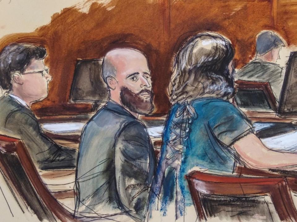 In this courtroom sketch, Joshua Schulte, center, is seated at the defense table flanked by his attorneys during jury deliberations, Wednesday (Elizabeth Williams)