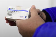 FILE - In this April 13, 2021, file photo, a box of Johnson & Johnson vaccines are shown by pharmacist Zsolt Szenasi at a warehouse of Hungaropharma, a Hungarian pharmaceutical wholesale company, in Budapest, Hungary. European nations are scrambling Wednesday, April 14, in the wake of Johnson & Johnson’s decision to delay the rollout of its COVID-19 vaccine amid reports of rare blood clots. (Szilard Koszticsak/MTI via AP, File)