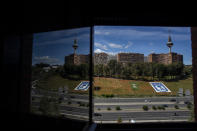 A view showing the area where Spanish flags were placed in memory of coronavirus (COVID-19) victims in Madrid, Spain, Sunday, Sept. 27, 2020. An association of families of coronavirus victims has planted what it says are 53,000 small Spanish flags in a Madrid park to honor the dead of the pandemic. (AP Photo/Manu Fernandez)