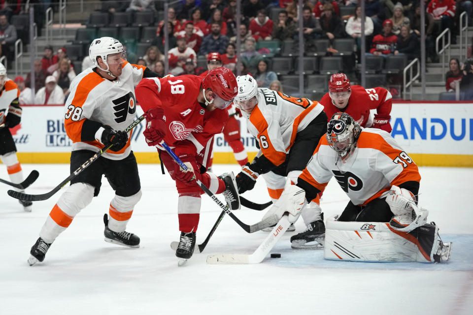 Philadelphia Flyers goaltender Carter Hart (79) stops a Detroit Red Wings center Andrew Copp (18) shot in the third period of an NHL hockey game Saturday, Jan. 21, 2023, in Detroit. (AP Photo/Paul Sancya)