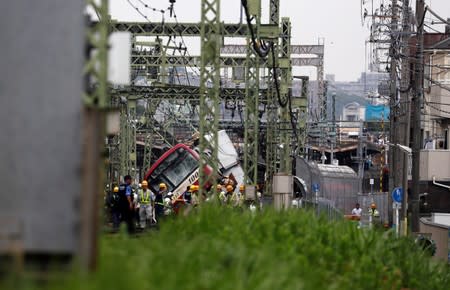 A train is seen derailed after a collision with a truck in Yokohama, near Tokyo, Japan