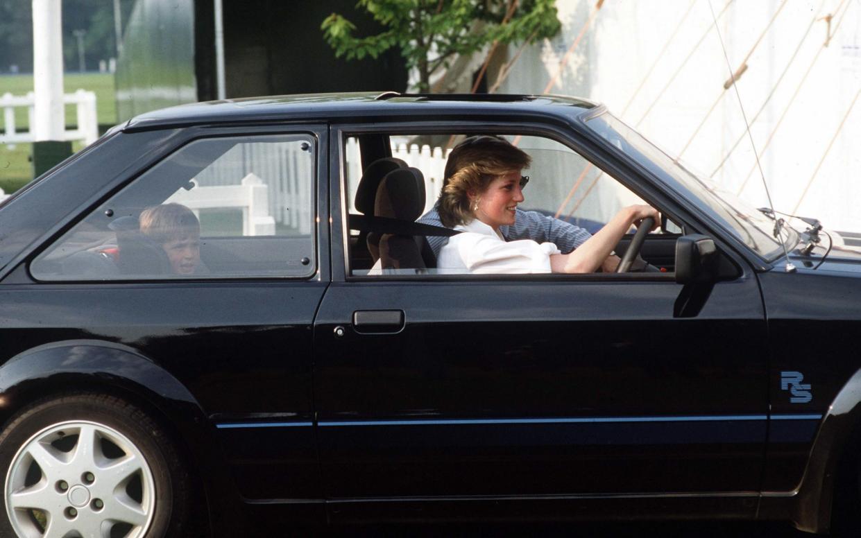 Princess Diana driving her Ford Escort, with Prince William seated in the back; the car sparked a bidding war in 2022