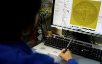 A sculptress from the Casa da Moeda do Brasil (Brazilian Mint) works on the Rio 2016 Olympic medal at her computer in Rio de Janeiro, Brazil, June 28, 2016. REUTERS/Sergio Moraes