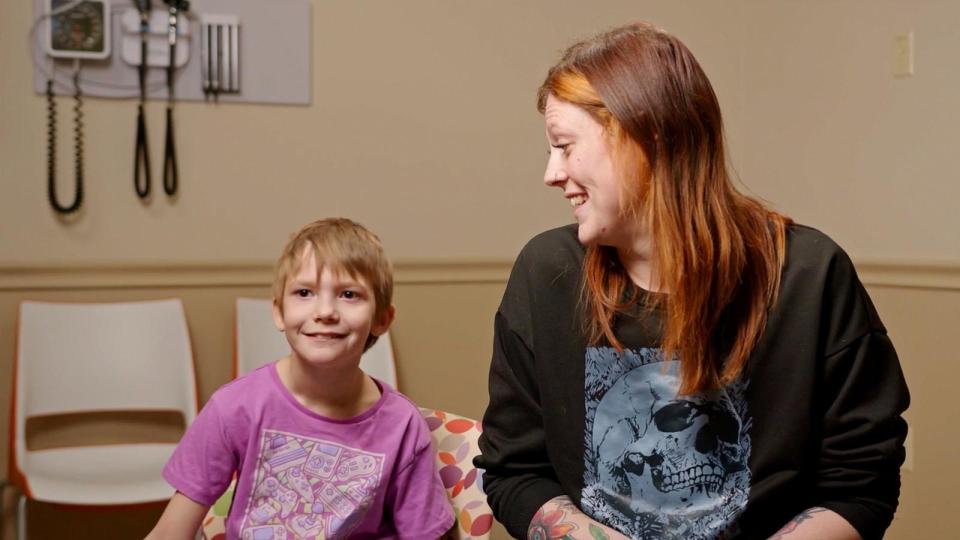 PHOTO: Karleigh Fry, 8, is the first pediatric patient to undergo robotic deep brain stimulation. Pictured: Karleigh (left) with her mother, Trisha Fry. (OU Health/Bethany Children’s Health Center)