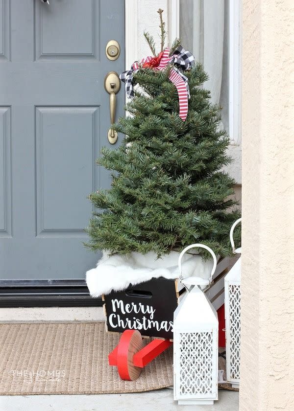 <p>Need a rustic touch for your porch? Make a super cute and festive wheelbarrow for your tree! This blogger turned a DIY fall apple cart into a Christmas one by adding a vinyl sign, painting the wheels red, and adding faux fur to hide the tree base. </p><p><strong>Get the tutorial at </strong><a href="https://thehomesihavemade.com/classic-christmas-porch-decor/" rel="nofollow noopener" target="_blank" data-ylk="slk:The Homes I Have Made." class="link "><strong>The Homes I Have Made.</strong></a></p>