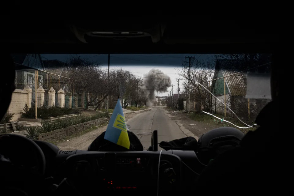 Smoke and dust waft in the air seconds after a Russian shell landed near the road in a suburb of Kherson, Ukraine, Feb. 4, 2023. (Ivor Prickett/The New York Times)