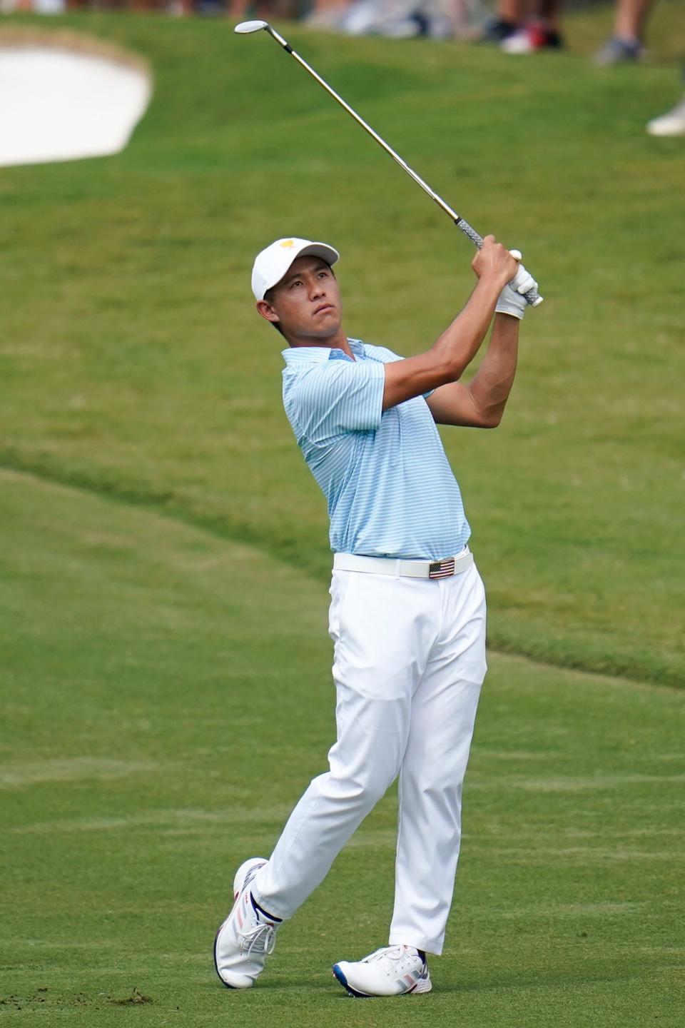 Collin Morikawa hits from the fifth fairway during their foursomes match at the Presidents Cup golf tournament at the Quail Hollow Club on Sept. 22, 2022, in Charlotte, N.C.
