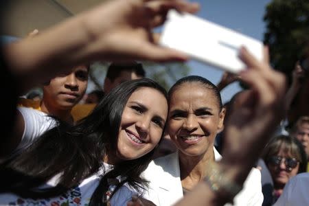 Brazilian Socialist Party (PSB) presidential candidate Marina Silva (R) poses for a "selfie" with a supporter during a campaign event in Brasilia, in this file picture taken September 22, 2014. REUTERS/Ueslei Marcelino/Files