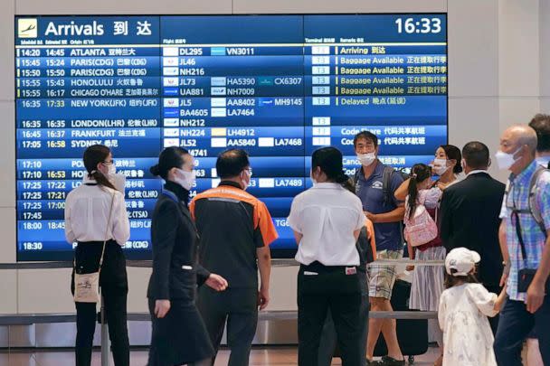 PHOTO: People wearing face masks are seen at an arrival lobby of Haneda airport in Tokyo on Aug. 23, 2022, amid the coronavirus pandemic. (Kyodo News via AP)