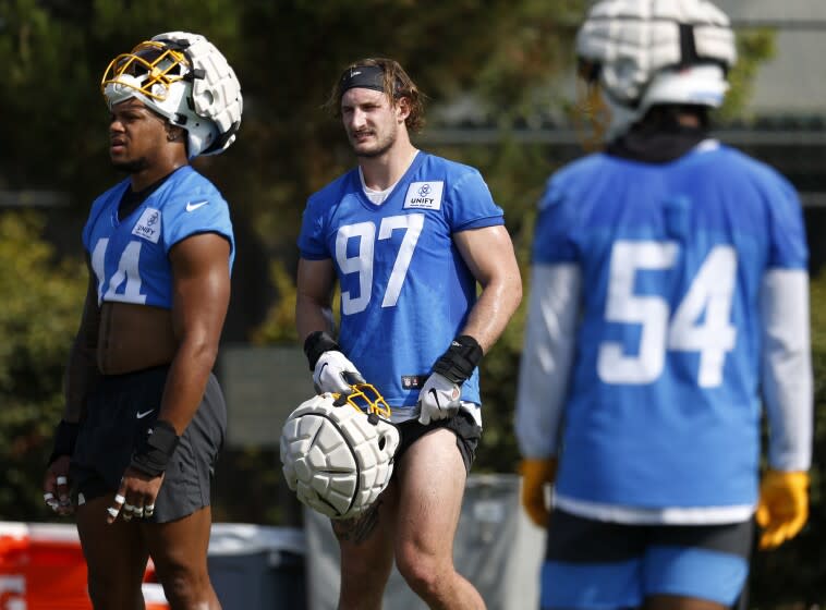 COSTA MESA, CA - JULY 28: Chargers linebacker Joey Bosa (97) is flanked by Jamal Davis II.