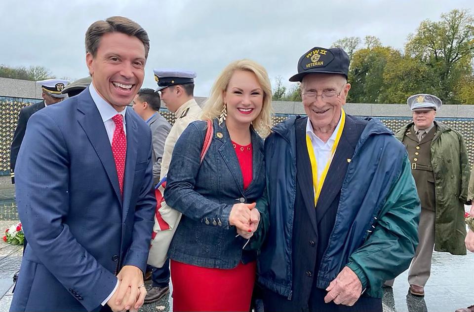 Matt and Melanie Miller greet a World War II veteran at a Veterans Day ceremony celebrating the D-Day Prayer addition to the World War II Memorial. A new monument is under construction at the site that will feature the prayer President Franklin D. Roosevelt recited for the soldiers on their D-Day landing. Melanie Miller was invited to sing at the celebration and her husband was invited to offer a benediction.