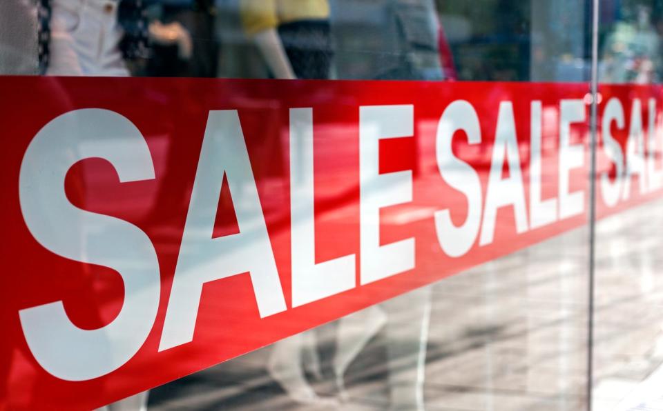 A sale banner in front of a store.