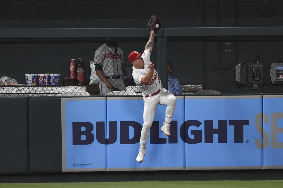 St. Louis Cardinals left fielder Tyler O'Neill jumps at the wall and catches a fly ball hit by Atlanta Braves' Adam Duvall during the eighth inning of a baseball game Tuesday, Aug. 3, 2021, in St. Louis. (AP Photo/Joe Puetz)