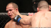 Cain Velasquez lands a punch on Junior dos Santos' face during their fight at UFC 155. (Courtesy: Tracy Lee for Y! Sports)