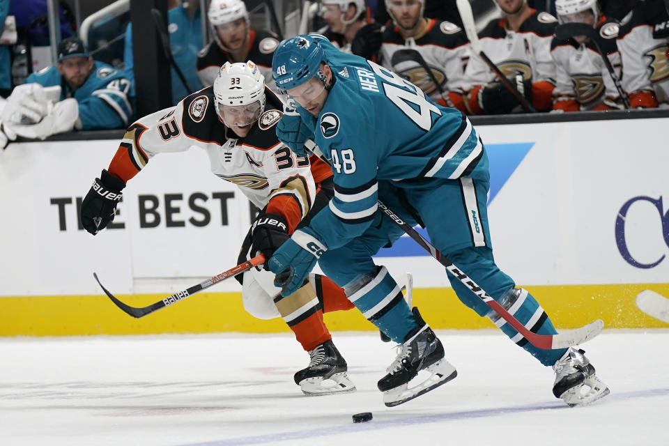 San Jose Sharks center Tomas Hertl (48) skates toward the puck in front of Anaheim Ducks right wing Jakob Silfverberg during the second period of an NHL hockey game in San Jose, Calif., Tuesday, Nov. 1, 2022. (AP Photo/Jeff Chiu)