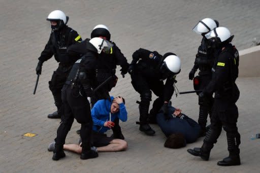 Polish anti-riot policemen detain Poland's football fans after tension posed the city's "greatest ever" security challenge in Warsaw. Police used an arsenal of tear gas, water cannon, rubber bullets and pepper spray and detained dozens of brawling football fans ahead of a key Euro 2012 match between Poland and Russia on Tuesday