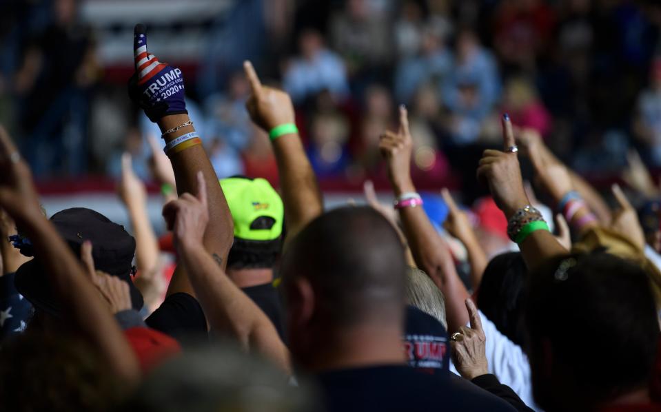 Audience members put their index finger up to symbolize America First while President Donald Trump speaks at a Save America Rally to support Republican candidates (Getty Images)