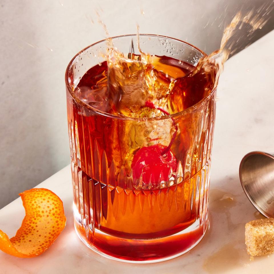 bourbon old fashioned with demerara sugar, bitters, maraschino cherry, and orange peel