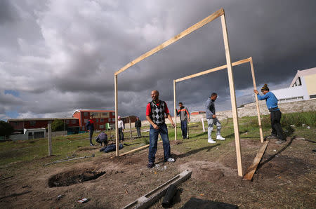 People erect a shack during illegal land occupations, in Mitchell's Plain township near Cape Town, South Africa, May 29, 2018. Picture taken May 29, 2018. REUTERS/Mike Hutchings