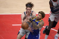 Golden State Warriors guard Kelly Oubre Jr., right, and Washington Wizards center Robin Lopez, left, battle for the ball during the second half of an NBA basketball game, Wednesday, April 21, 2021, in Washington. (AP Photo/Nick Wass)