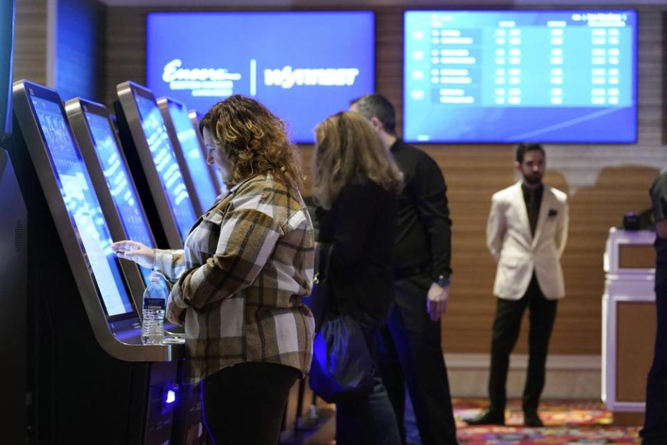 Patrons place sports bets at kiosks at Encore Boston Harbor in Everett on Jan. 31, the first day of legalized sports betting in Massachusetts.