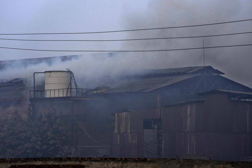 Smoke erupts from a small iron factory in Lahore, Pakistan, Monday, Jan. 15, 2024. Lahore is in an airshed, an area where pollutants from industry, transportation and other human activities get trapped and cannot disperse easily. (AP Photo/K.M. Chaudary)