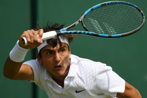 Roman Burruchaga hits a return on Wimbledon's Court Five