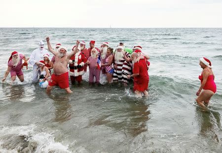 People dressed as Santa Claus take take part in the World Santa Claus Congress, an annual event held every summer in Copenhagen, Denmark, July 25, 2017. REUTERS/Stine Jacobsen