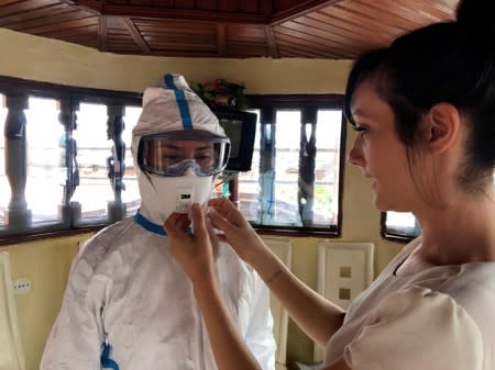 Reuters text reporter Alessandra Prentice dresses in an Ebola protective suit during training in Butembo