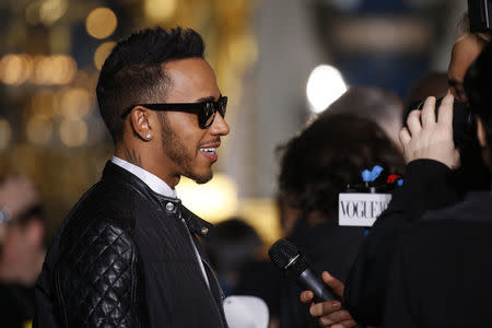 Formula One driver Lewis Hamilton attends the Stella McCartney Fall/Winter 2016/2017 women's ready-to-wear collection show in Paris, France, March 7, 2016. REUTERS/Benoit Tessier