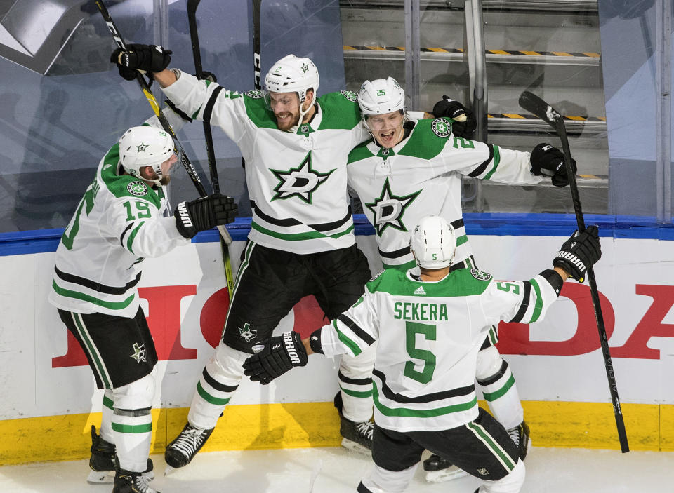 Dallas Stars' Blake Comeau (15), Jamie Oleksiak (2), Joel Kiviranta (25) and Andrej Sekera (5) celebrate the winning goal against the Colorado Avalanche during overtime of an NHL Western Conference Stanley Cup playoff game in Edmonton, Alberta, Friday, Sept. 4, 2020. (Jason Franson/The Canadian Press via AP)