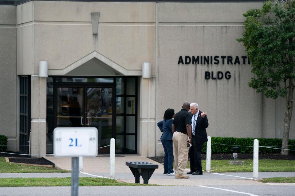 Prison officials confer outside the Riverbend Maximum Security Institution after the execution of Oscar Franklin Smith was postponed Thursday, April 21, 2022 in Nashville, Tenn. 