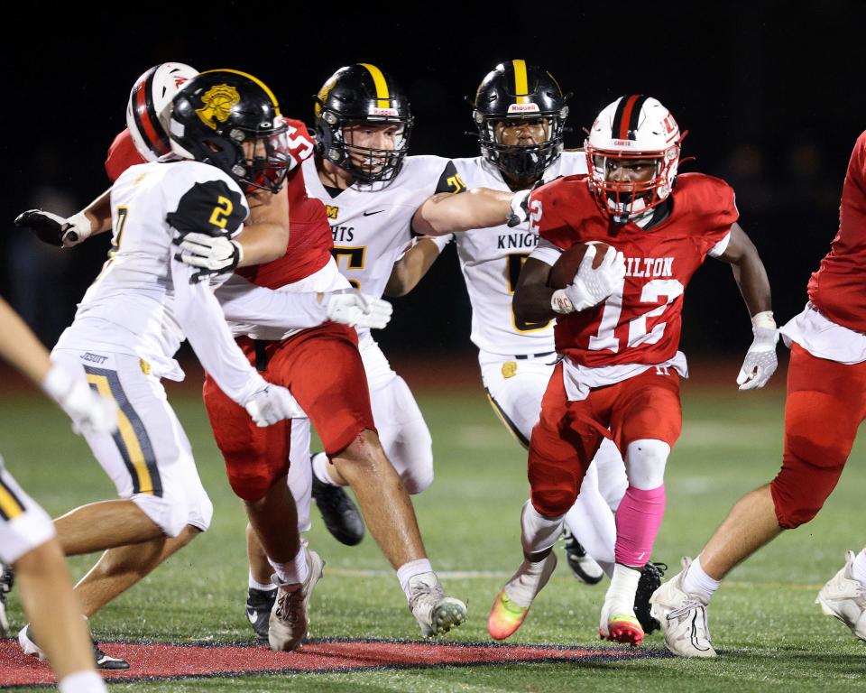 Hilton running back Robert Lowry finds a hole at the line of scrimmage.