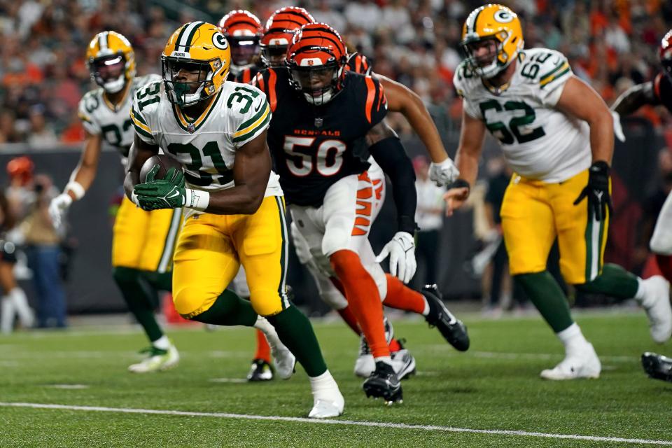 Green Bay Packers running back Emanuel Wilson scores a touchdown in the third quarter against the Cincinnati Bengals. He scored on two touchdown runs, including an 80-yarder in the fourth quarter.