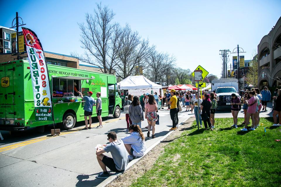 People wait in line for food trucks during the first Iowa City Farmers Market of the season, Saturday, May 7, 2022, at the Chauncey Swan Parking Ramp in Iowa City, Iowa.