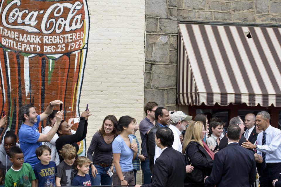 President Barack Obama (right) greets people outside Manuel's Tavern after an interview March 10, 2015, in Atlanta, Georgia. Obama traveled to Georgia for the day where he spoke to students about affordable schooling. 