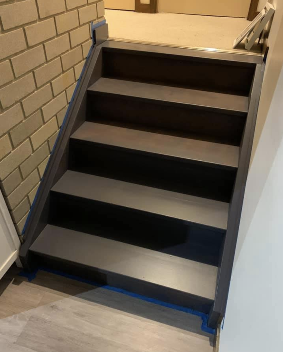 Photo shows set of stairs after being painted black by a tipsy mum.