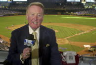 FILE - In this July 3, 2002 file photo, Los Angeles Dodgers television play-by-play announcer Vin Scully rehearses before a baseball game between the Dodgers and the Arizona Diamondbacks in Phoenix. Some of the most familiar voices have left in recent years. The Dodgers’ Vin Scully _ recognized within the business as one of the best ever _ retired after the 2016 season, his 67th. (AP Photo/Paul Connors, File)