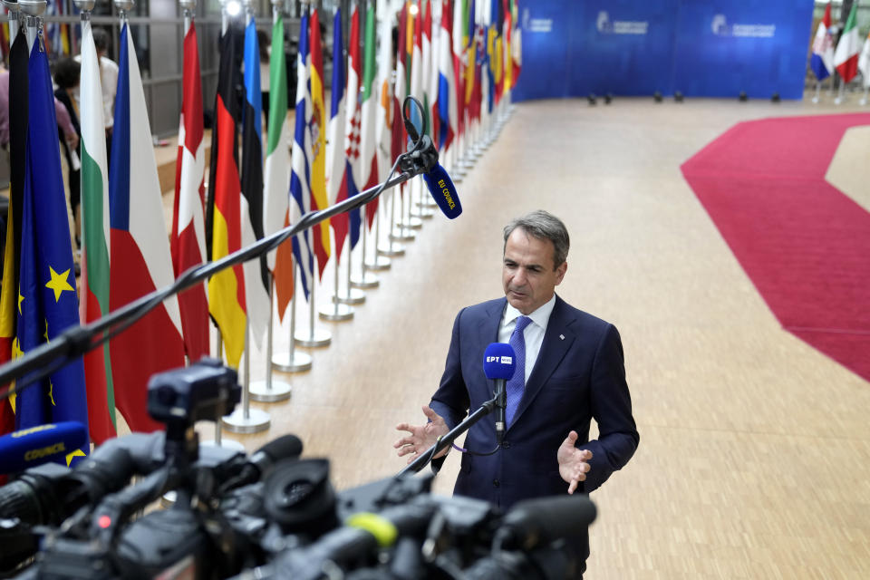 Greece's Prime Minister Kyriakos Mitsotakis speaks with the media as he arrives for an EU summit at the European Council building in Brussels, Thursday, June 29, 2023. European leaders meet for a two-day summit to discuss Ukraine, migration and the economy. (AP Photo/Virginia Mayo)