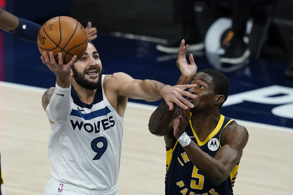 Minnesota Timberwolves' Ricky Rubio (9) goes to the basket against Indiana Pacers' Edmond Sumner (5) during the first half of an NBA basketball game, Wednesday, April 7, 2021, in Indianapolis. (AP Photo/Darron Cummings)