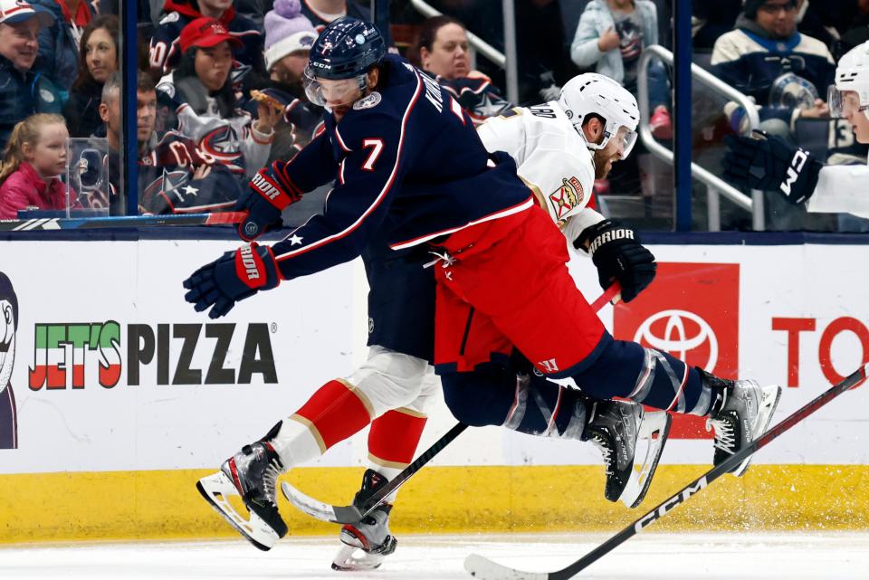Columbus Blue Jackets forward Sean Kuraly, left, collides with Florida Panthers defenseman Aaron Ekblad during the second period of an NHL hockey game in Columbus, Ohio, Sunday, Dec. 10, 2023. (AP Photo/Paul Vernon)