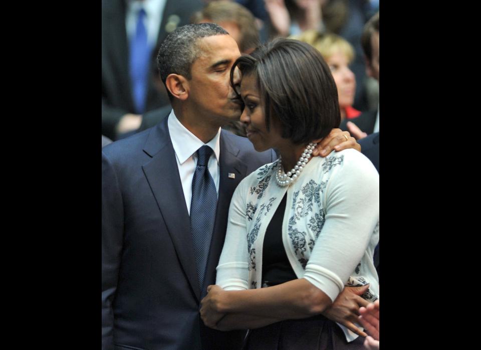 US President Barack Obama kisses First Lady Michelle Obama after addressing the memorial event Together We Thrive: Tucson and America' at the McKale Memorial Center in Tucson, Arizona, on January 12, 2011. Obama led a tribute service for the six people who were killed and the 14 wounded in the assassination attempt on congresswoman Gabrielle Giffords, who is fighting for her life in a hospital. AFP PHOTO/Jewel Samad (Photo credit should read JEWEL SAMAD/AFP/Getty Images)