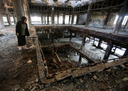 Raghad Hammoudi, who is a member of a group of students campaigning to help rebuild the Central Library of Mosul University, is seen in Mosul, Iraq May 14, 2018. Picture taken May 14, 2018. REUTERS/Khalid Al-Mousily