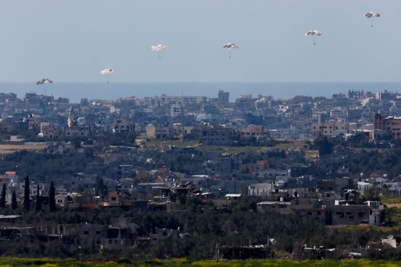 Packages fall towards northern Gaza, as seen from Israel